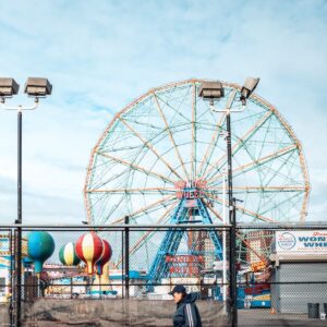 person passing by an amusement park