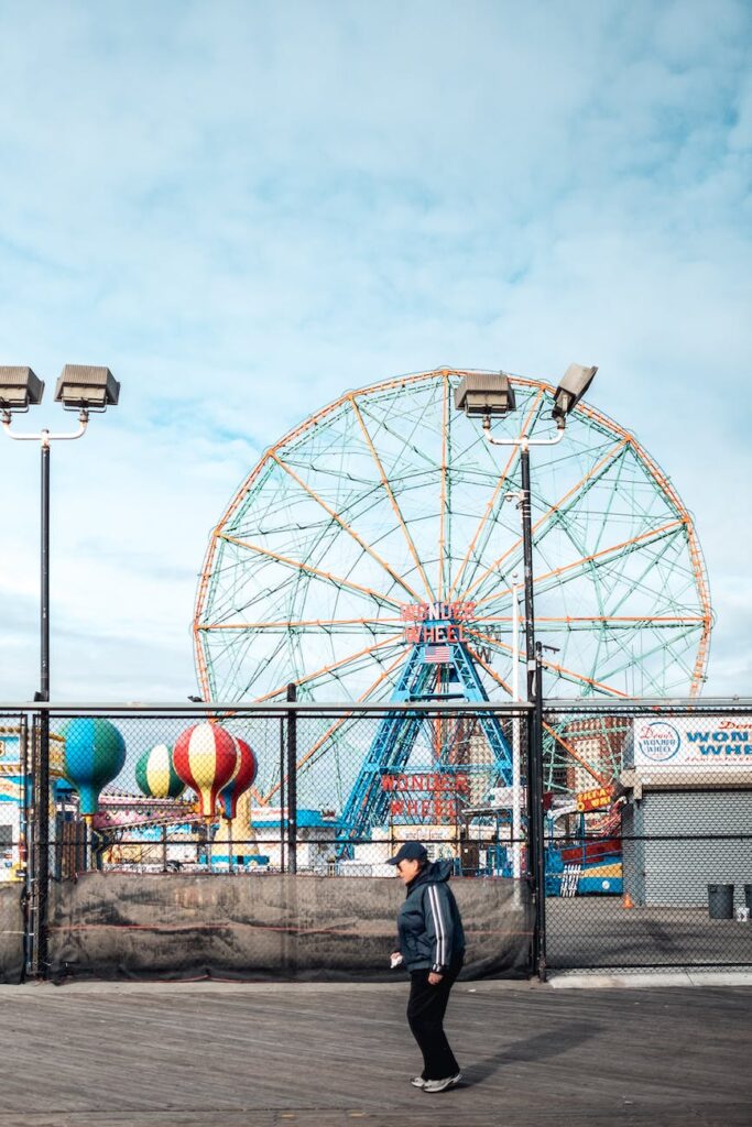 person passing by an amusement park