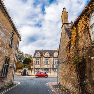 red car parked beside brown concrete building